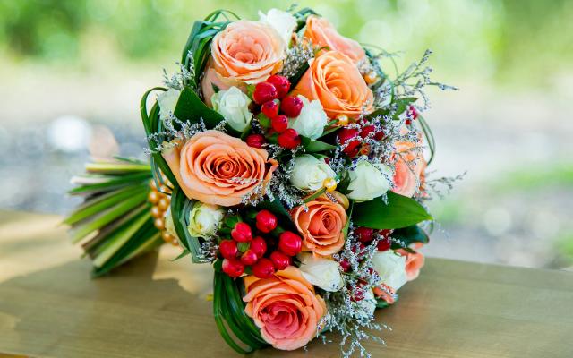 Festive simple wedding bouquet with red hues, berries and sparkly decor 