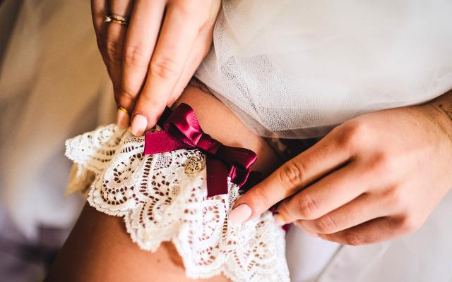 Bride putting on a wedding garter