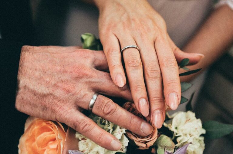 Older couple holding hands after renewing their wedding vows