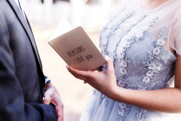 Couple reading out their vows at vow renewal ceremony