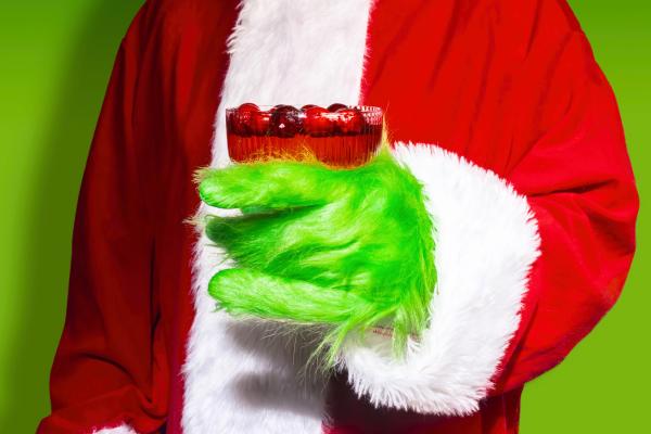 Person dressed as the grinch for Christmas Character Themed Party, one of the best Work Christmas Party Ideas